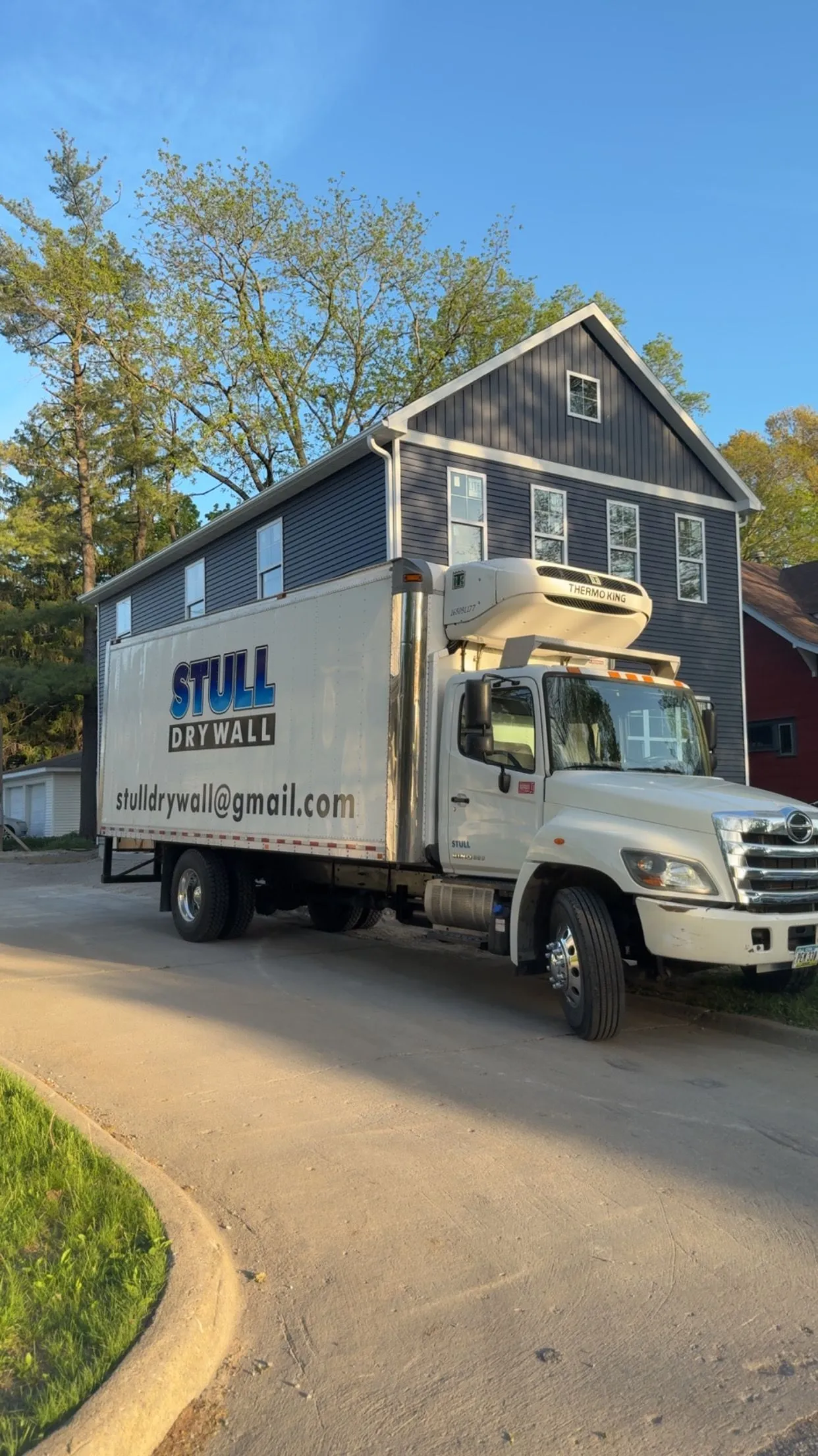 Stull Drywall truck parked at a home construction site